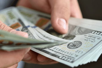 Close up of businessman counting money in hands