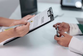 woman holding resume while interviewing for job