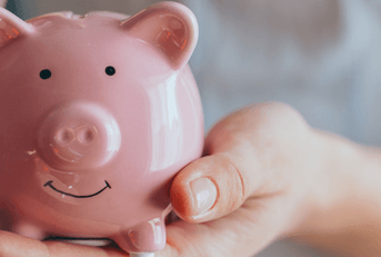Someone holding a piggy bank