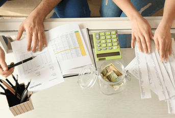 Couple calculating expenses and paying bills