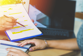 Legal team checking the fine print on business contract to analyze terms and conditions and sign