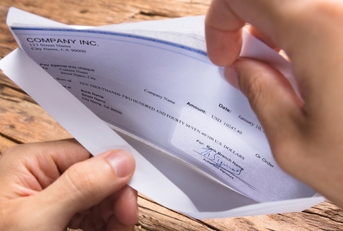 Businessman Opening Envelope With Paycheck
