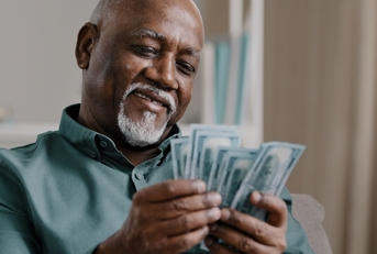 happy african american man counting money