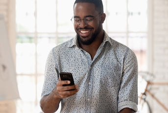 Smiling man using phone