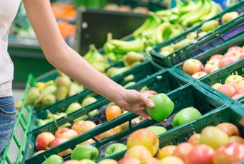 A woman choosing an apple