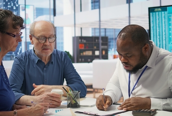 senior citizens consulting a broker