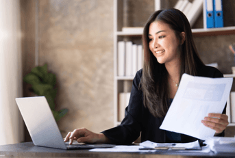A woman works on her computer. 