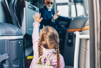 Little girl going into the bus