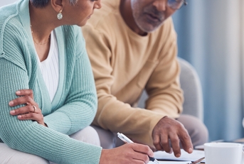 senior couple signing a contract