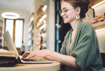 A woman types on her laptop.
