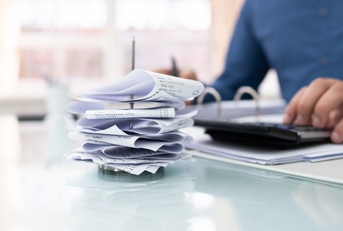 businessman calculating invoice