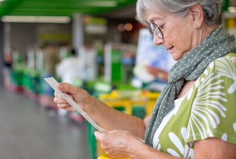 checks her grocery receipt