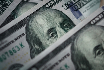 Several one hundred dollar bills at table