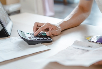 Close up person calculating expenses