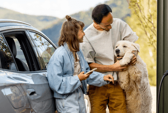 couple with dog at EV charging station