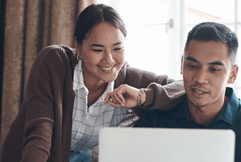 couple working on budget on their laptop