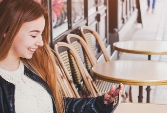 Woman sitting outside cafe