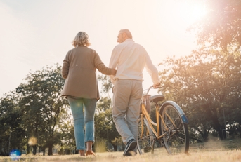 Senior Couple Holding Bike