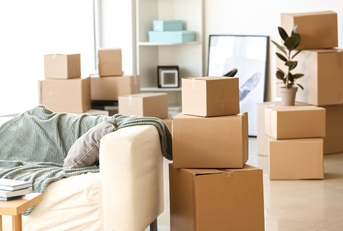 Furniture and moving boxes in room