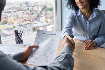 Manager shaking hands with worker