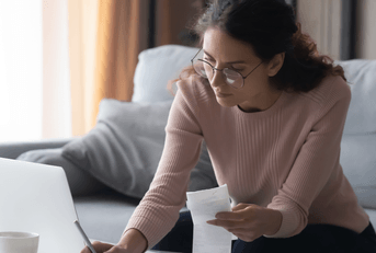 Young woman working on bills