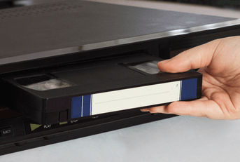 Inserting VHS tape into player 