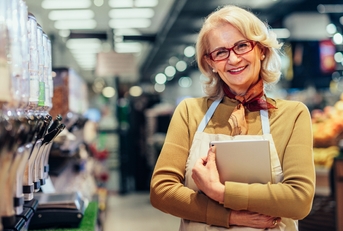 Owner standing in a grocery store