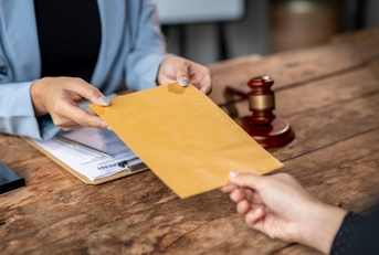 lawyer delivering legal documents in envelope