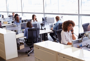 workers in busy open plan office 
