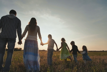 Family walking on the floor at sunset