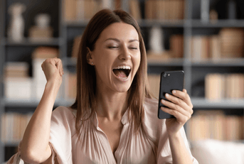 Very happy woman looking at phone