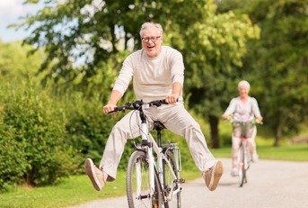 happy senior couple riding bicycles