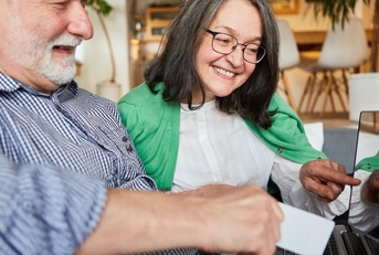 senior couple have fun online shopping
