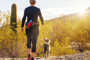 woman hiking with dog