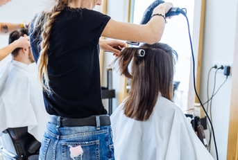 woman drying hair in hair salon 