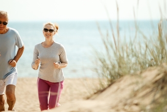 cheerful and active couple retired spouses jogging in the morning