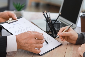 man signing documents