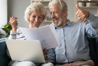 spouses check documents feels happy about pay debt off