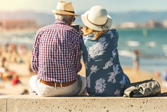 retired lovers enjoying retirement on the beach