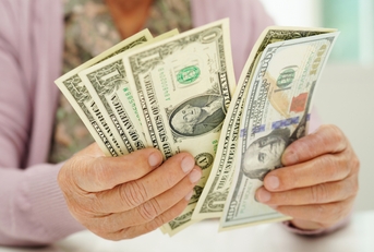 elderly woman counting money