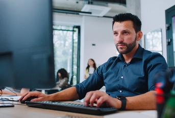 man in shirt working