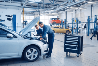 mechanics working on car