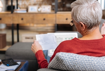 lying on the sofa and reading documents