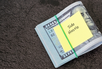 dollar bills and adhesive note