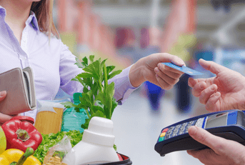 person using credit card on groceries