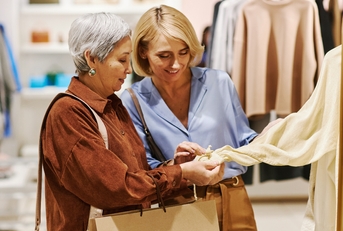 adult woman with mother shopping together in boutique 