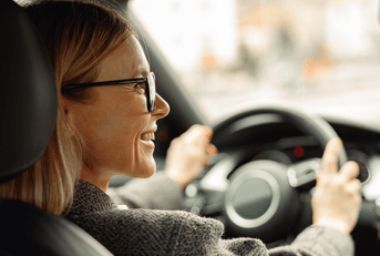 Smiling woman driving a car