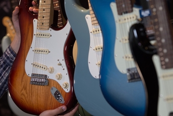 Many electric guitars hanging