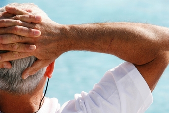 senior man leaning on chair