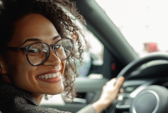 Smiling woman driving a car